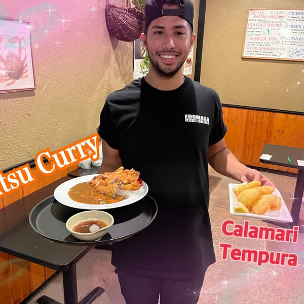 Edomasa Sushi Bar & Restaurant staff member holding Katsu Curry and Calamari Tempura.